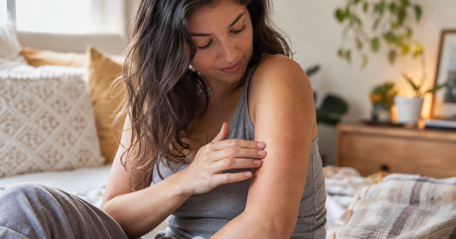 Woman examining the texture of bumps on her arm, checking whether it's papular eczema or keratosis pilaris