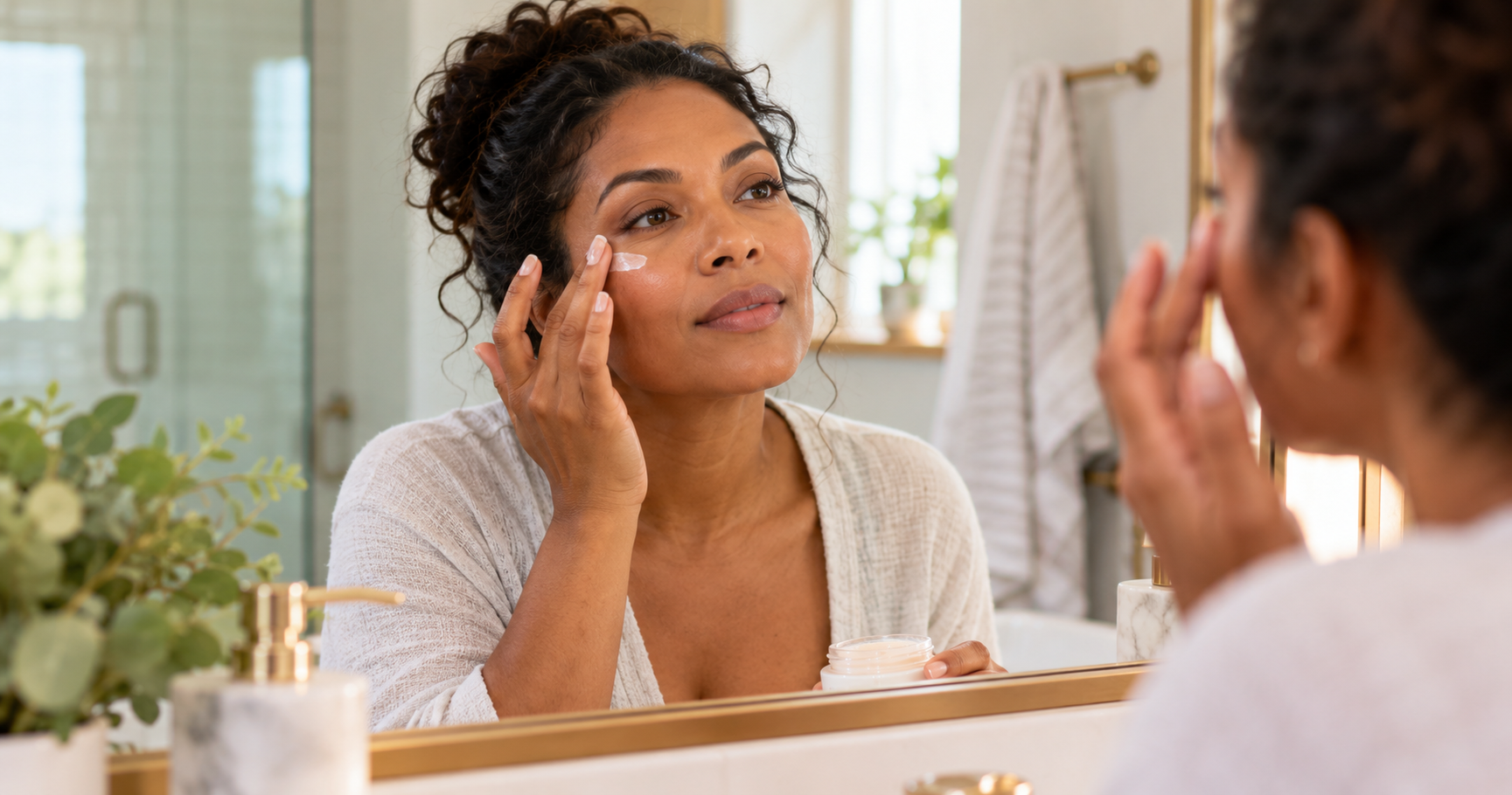Woman gently applying a non-greasy moisturizer near her eye area to manage eyelid eczema